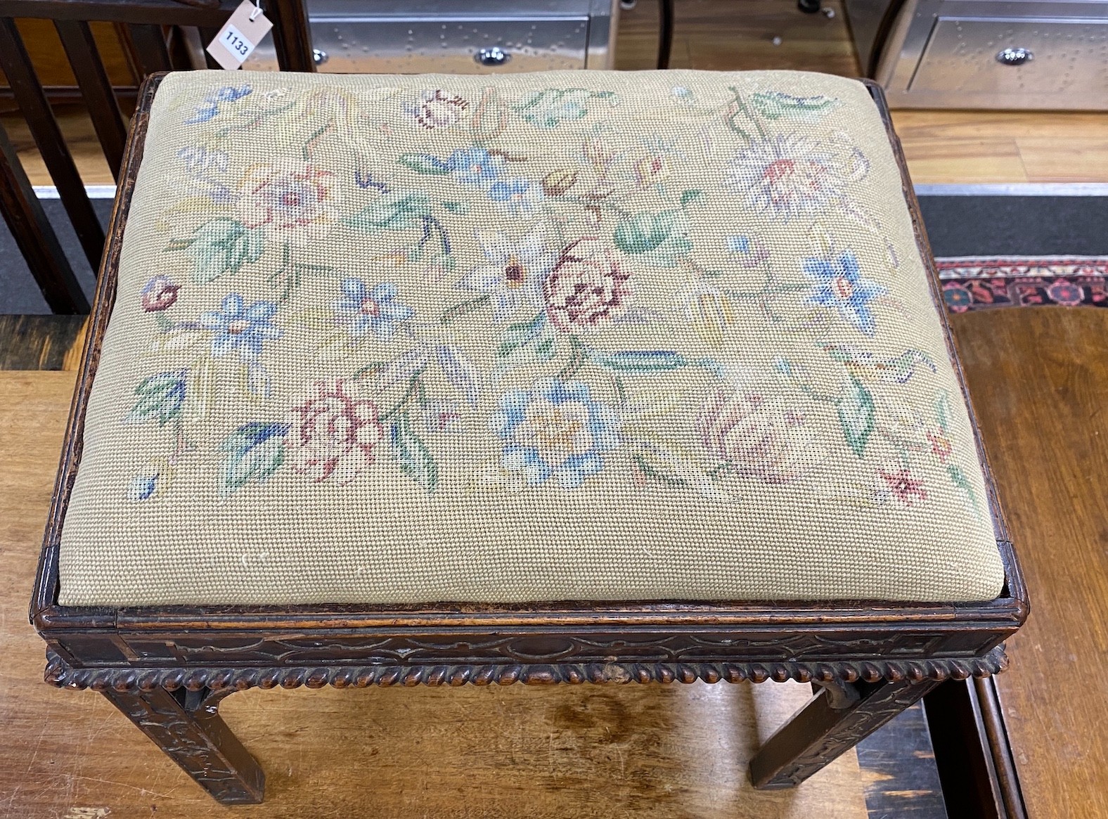 A Chippendale revival mahogany dressing stool with needlework drop in seat and blind fret carving, width 53cm, height 47cm